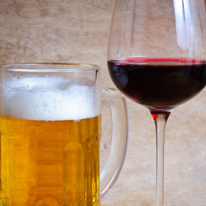 Photo of beer in a mug and wine in a glass. 