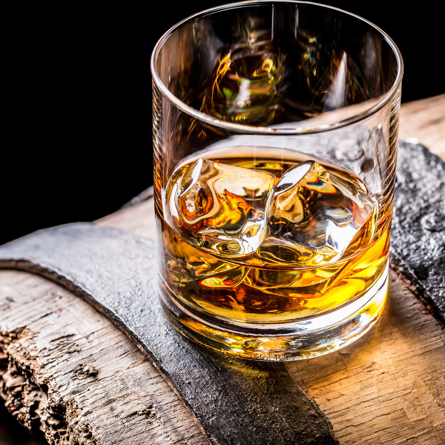 Picture of a highball glass with bourbon in it.