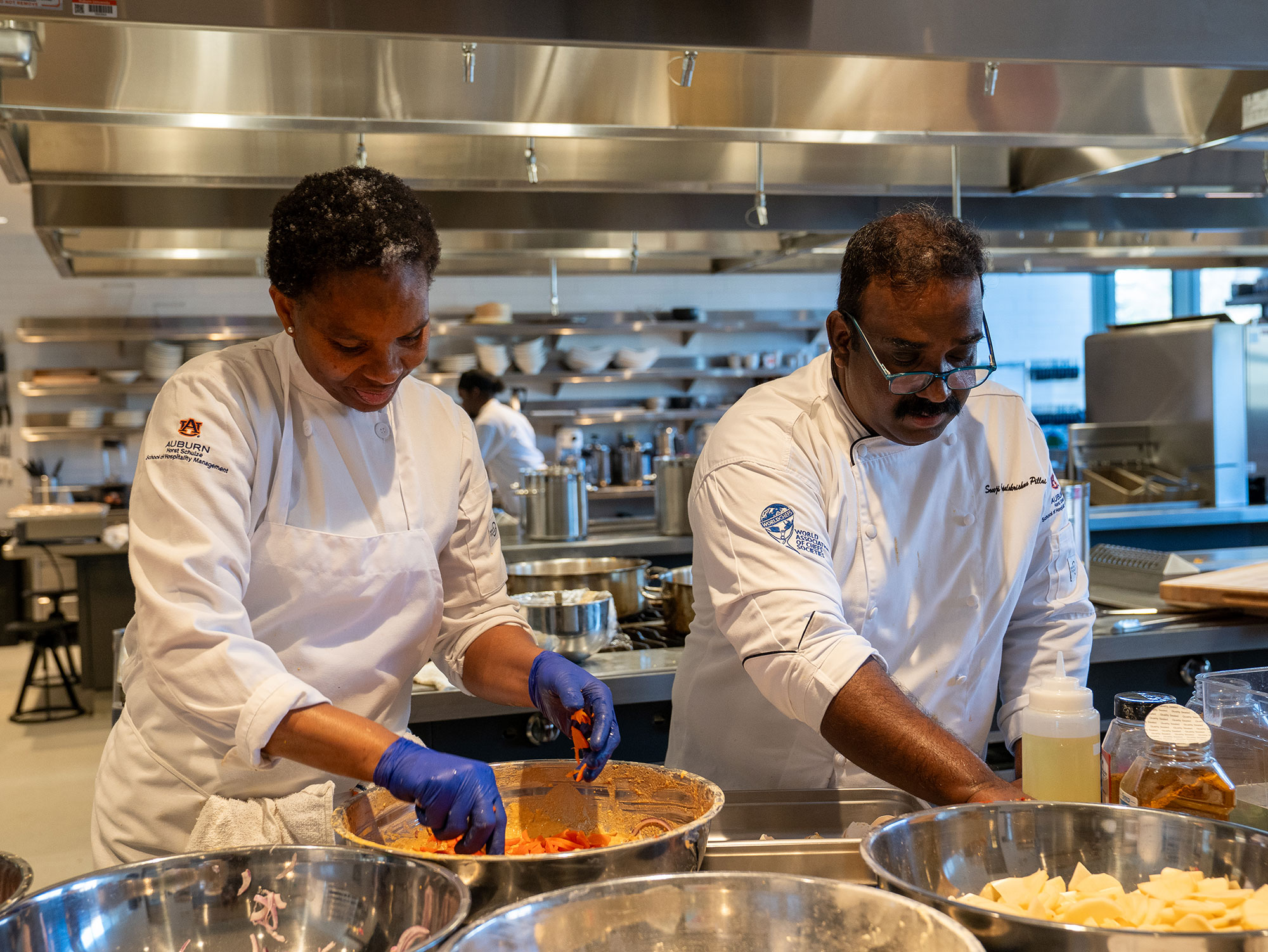 Graduate students cooking in lab.