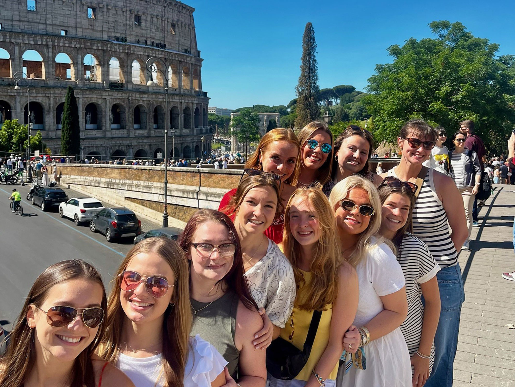 Study Abroad student selfie with The Colosseum, Rome in the background.