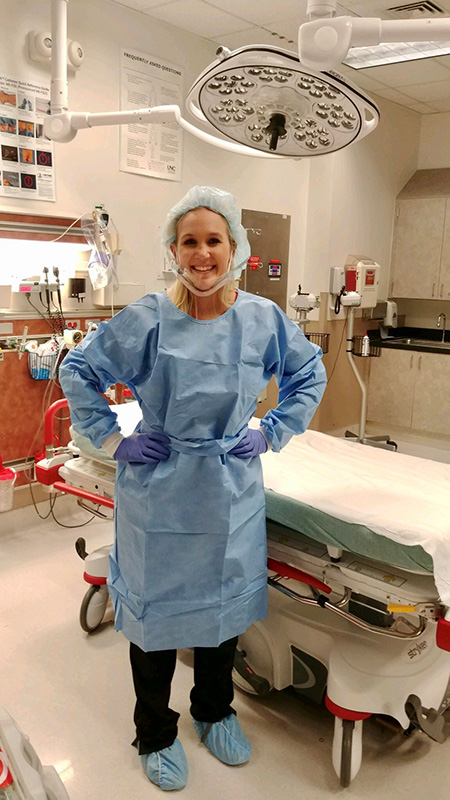 Student in scrubs in an operating room.
