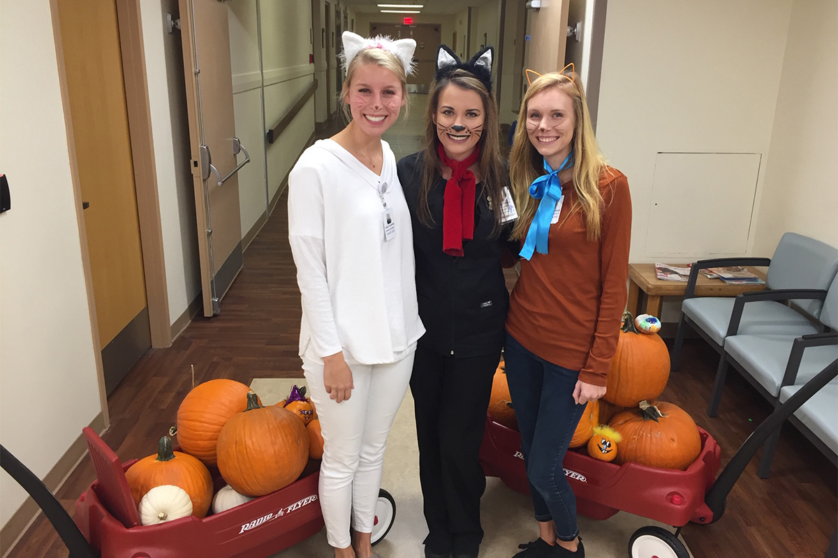 Three students dressed in Halloween costumes.