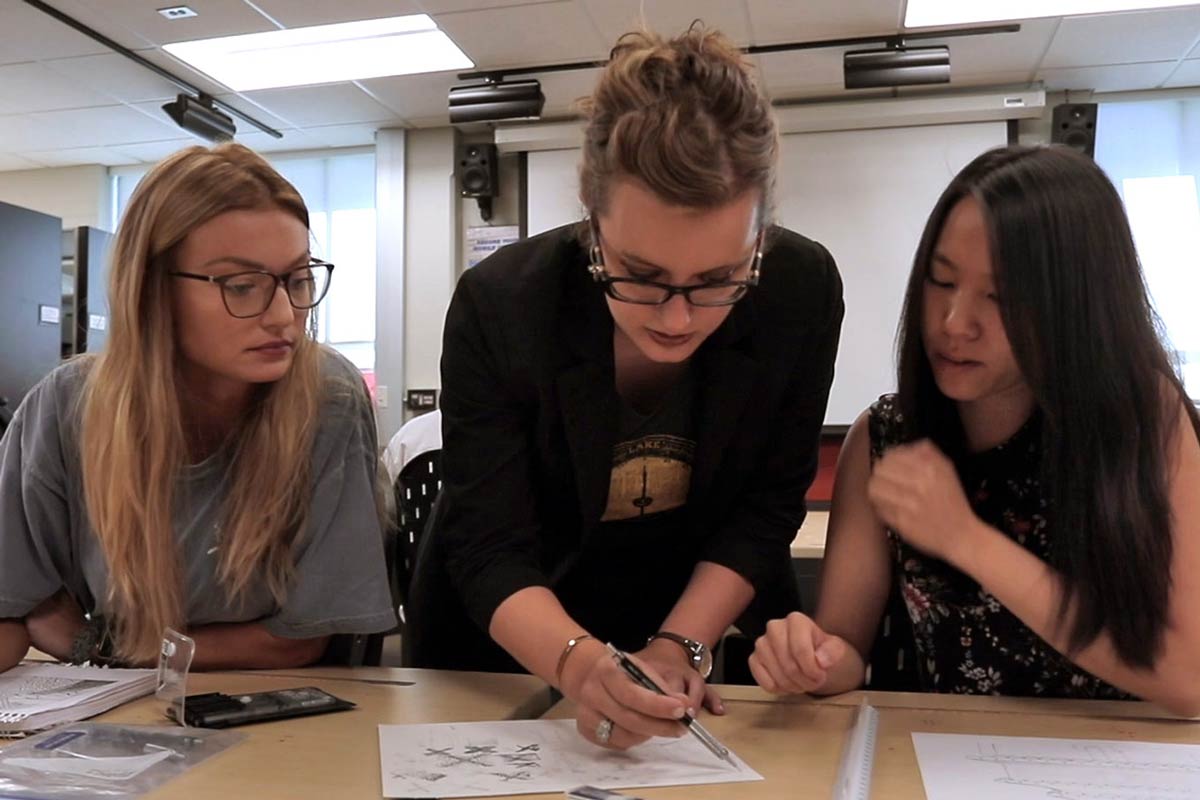Anna Ruth Gatlin helping a couple of interior design students.