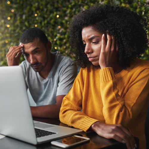 Couple sitting a computer for a therapy session.
